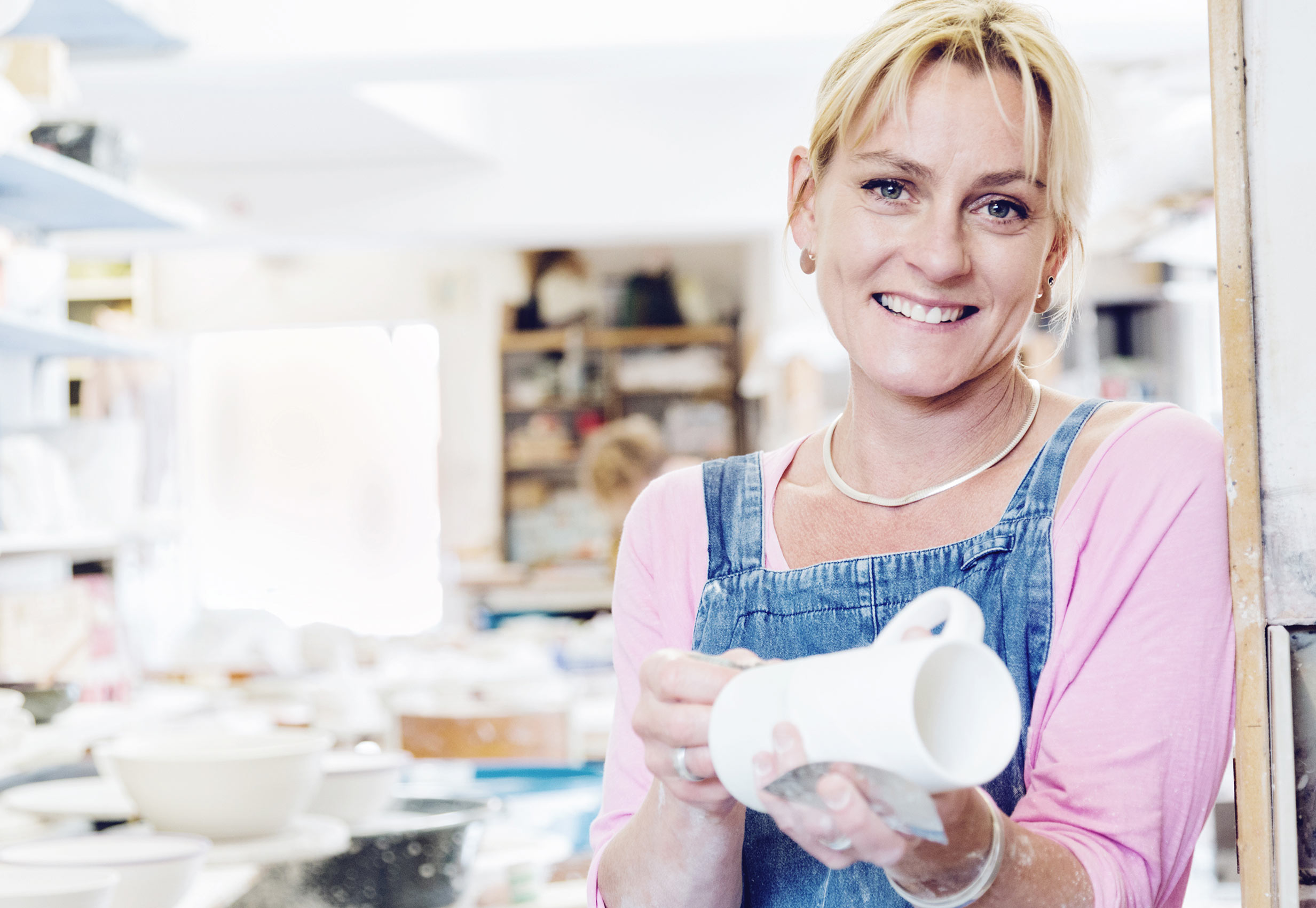Small business photography - london - female potter holding mug.  Photographed on location in London.  Small business photography, Surrey, UK