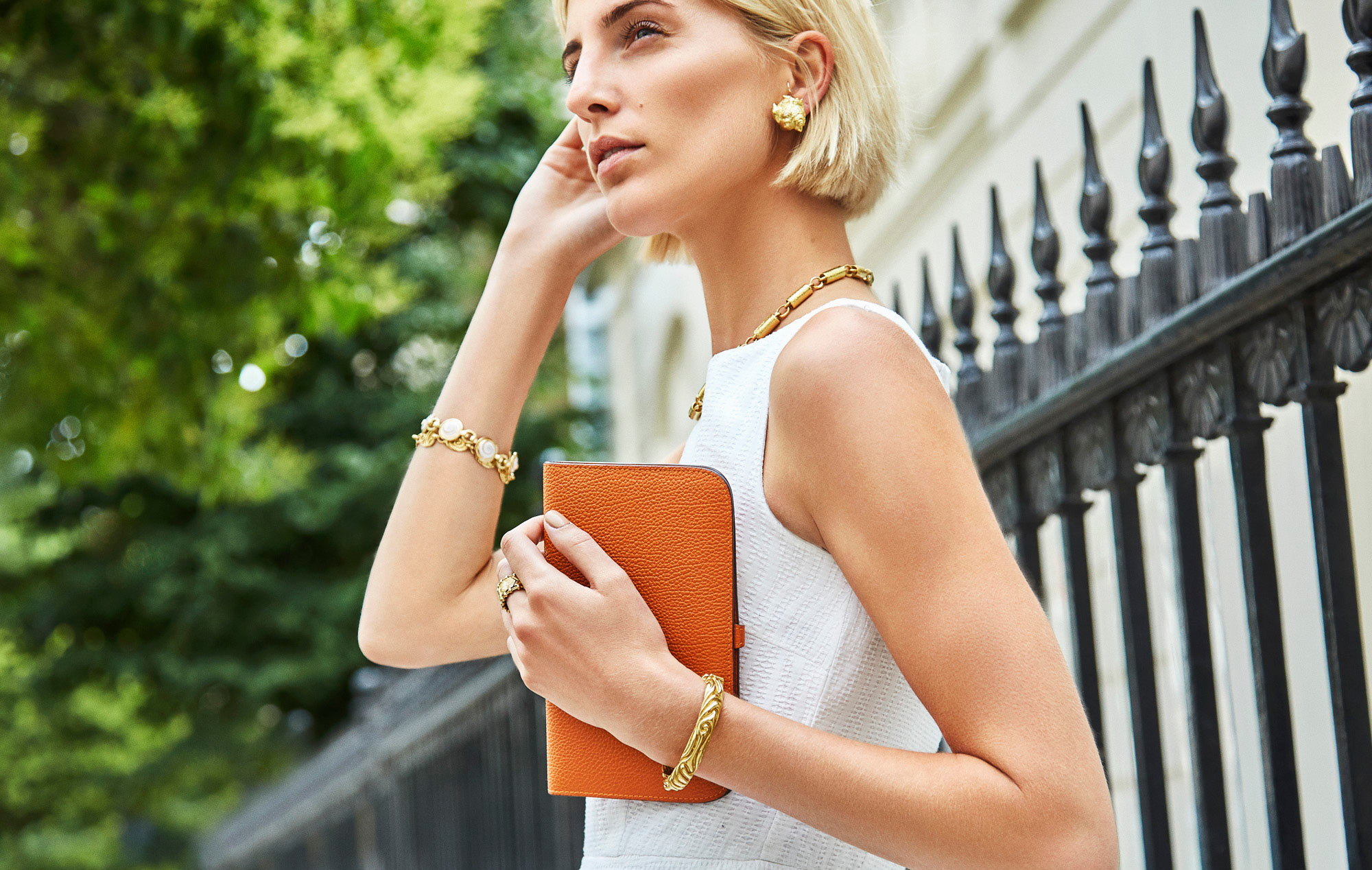 Lifestyle photographer london - model wearing designer jewels carrying leather handbag.  Advertising  photography for luxury jeweller
