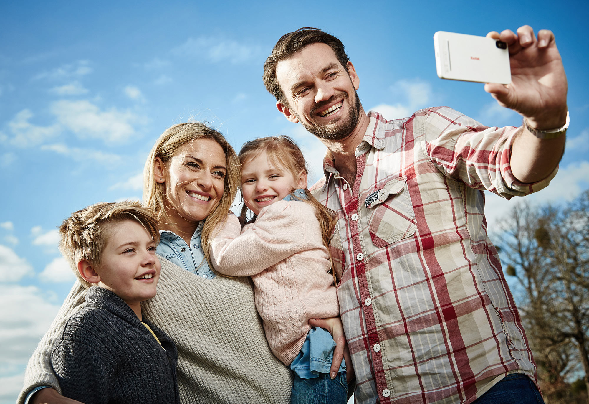 Lifestyle photographer, surrey, UK.  Family taking a selfie.  Photographed for mobile phone company in Sussex, UK
